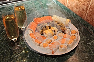 A romantic dinner , champagne glasses and sushi