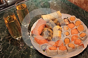 A romantic dinner , champagne glasses and sushi