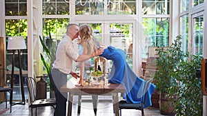 Romantic dinner for couple. girl with glass stands on table to kiss boyfriend.