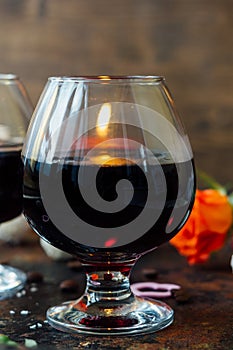 Romantic dinner drink - wine or brendy in glass.