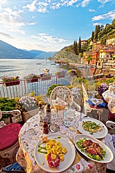 Romantic dinner scene of plated Italian food on terrace overlook