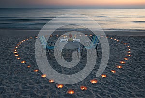 Romantic dinner on the sea beach with candle heart