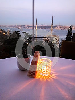 Romantic dinner setting in the restaurant in Istanbul wiht amazing view on the Bosphorus and mosques