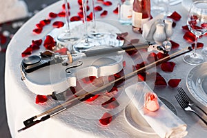 Romantic dinner setup, red decoration with rose petals in a restaurant