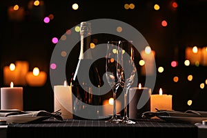 Romantic dinner table setting with burning candles