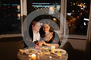 romantic dinner for two with candles, date by candlelight with wine, couple in love on valentine's day, man and woman