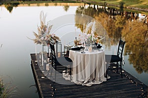 Romantic dinner for two by the lake at sunset