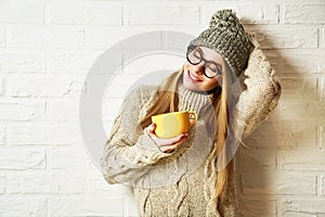 Romantic Dreaming Hipster Girl in Winter Clothes with a Mug