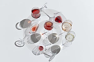 Romantic drink. Glasses filled with red, white and rose wine against white background. Tasting