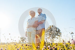 Romantic elderly couple enjoying health and nature in a sunny da