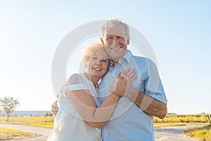 Romantic elderly couple enjoying health and nature in a sunny da