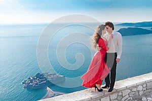Romantic embracing couple beside blue sea. Love. Fashion girl in