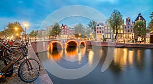 Romantic Evening in Amsterdam. Panoramic views of the famous old houses, bicycles, bridge and canal in the old center.   Amsterdam