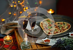 Romantic evening with champagne, candles and heart shaped Pizza. Love. Celebrate holidays