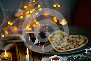 Romantic evening with champagne, candles, heart shaped Pizza. Love. Celebrate holidays. Cozy. Home related