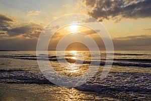 Romantic evening and magic sunset on sandy beach of Crete, Greece. Walk on the beach during beautiful sunset. Silhouette