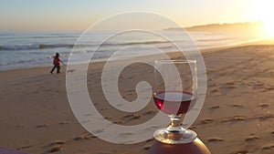 Romantic evening mood with a glass of red wine at the sea