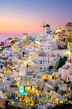 Romantic evening view of traditional Greek village Oia on Santorini island in Greece. Santorini is iconic travel destination in