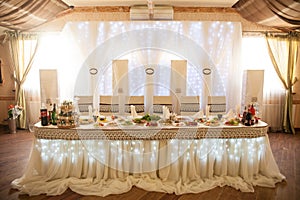 Romantic fairytale catered white table at wedding reception with