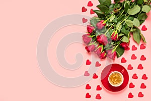 Romantic flat lay with red cup of coffee, roses and hearts on pink background. Mother's, women's or Valentine's day