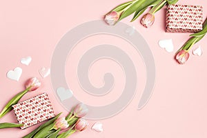 Romantic floral frame background with tulips, gifts and hearts on pink pastel background