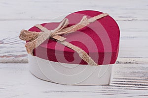 Romantic gift box on wooden background.