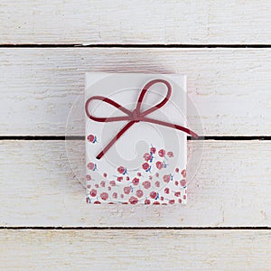 Romantic Gift box on wooden table. View from above.