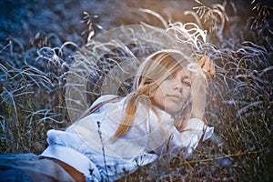 Romantic girl lying in grass