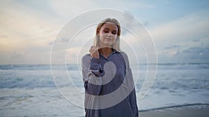 Romantic girl ocean sunset alone. Closeup smiling travel woman looking camera