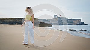 Romantic girl walking seashore summer weekend. Carefree woman strolling beach