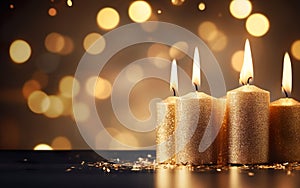 Romantic golden candles on table with blurred sparkling bokeh background. Christmas lights.