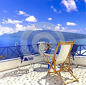 Romantic greek holidays in most beuatiful island Santorini. coffe table with gorgeous caldera and volcano view