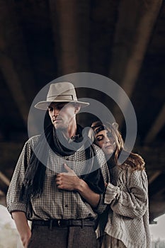 Romantic gypsy woman in stylish boho clothes and white dress hug