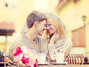 Romantic happy couple kissing in the cafe