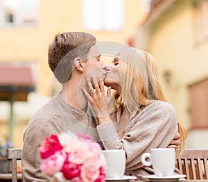 Romantic happy couple kissing in the cafe