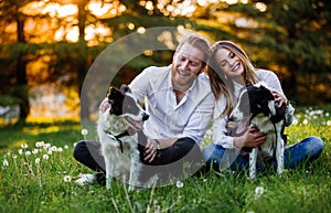 Romantic happy couple in love enjoying their time with pets in nature
