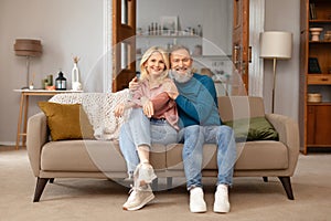 Romantic happy mature couple relaxing on couch at home