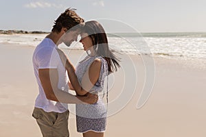 Romantic happy young couple head to head on beach