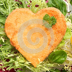 Romantic heart shaped fried golden schnitzel