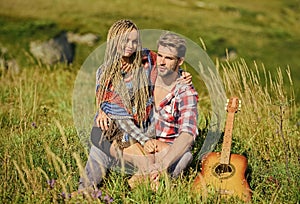 Romantic hike. Family hike. Boyfriend and girlfriend with guitar in mountains. Enjoying each other. Summer hike