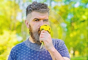 Romantic hipster made bouquet, green nature background, defocused. Aroma concept. Man with beard and mustache on calm