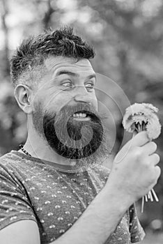 Romantic hipster made bouquet, green nature background, defocused. Romantic concept. Man with beard and mustache on