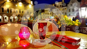 Romantic holiday city light Street cafe  bokeh blurring city light evening restaurant table cup of coffee on top view candle lamp