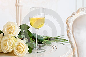 Romantic holiday composition with wine glass and roses for Valentines Day. Love, gift and spring holiday background.