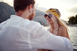 Romantic holiday. Girl sitting  on lake bank and enjoying