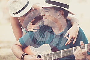 Romantic hug an colors with cheerful happy middle age people in love playing a guitar together looking and smiling - relationship