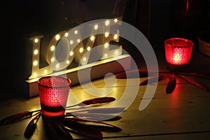 Romantic image with candles and the word love bright