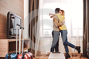 Romantic jorney. Couple kissing in rental appartment while traveling photo