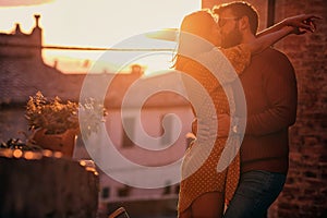 Romantic kiss at  beautiful sunset.Young couple in love photo