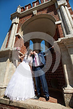 Romantic kiss bride and groom and ancient building